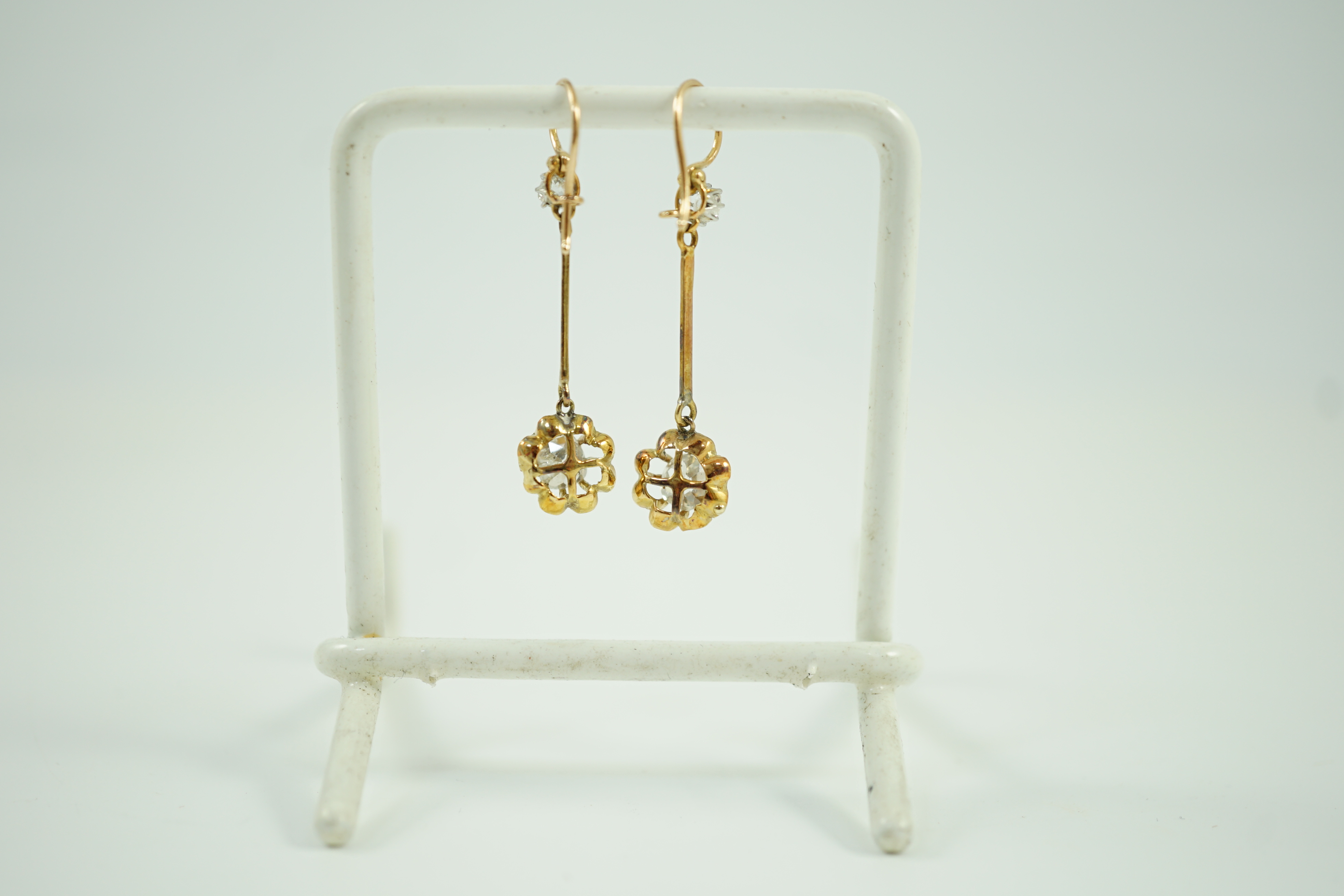 A pair of late 19th/early 20th century gold and four stone diamond set drop earrings